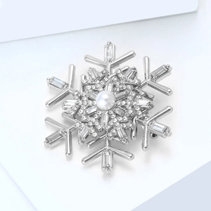 Macro detail of snowflake brooch with silver plating, inlaid pearl, and sparkling zircon
