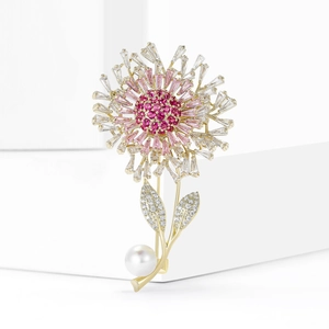 Elegant dandelion brooch with pink cubic zirconia stones and a white pearl on a gold base