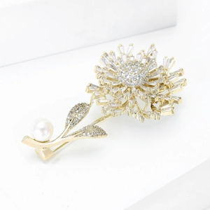 Detailed view of luxury golden dandelion brooch with sparkling zircons and pearl