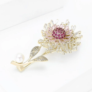Detail of flower brooch with pink zircons and white pearl on a golden stem