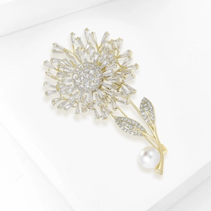 Detail of luxury dandelion brooch with sparkling zircons and a white pearl accent