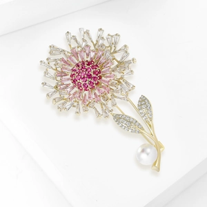 Detail of flower brooch with pink zircons, gold metal petals, and a large white pearl