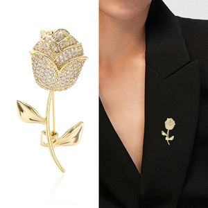 Elegant gold rose brooch with sparkling crystals on black blazer for classic formal style