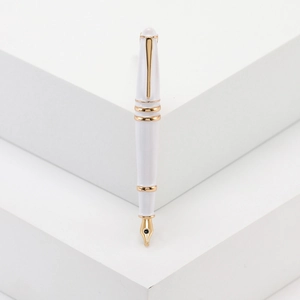 Eleganter weißer und goldener Füllfederhalter-Broschen-Anstecker auf weißem Sockel