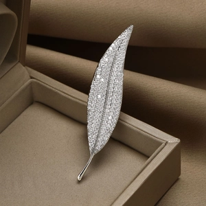 Elegant leaf brooch with micro-paved cubic zirconia stones on silver metallic base