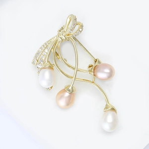 Elegant gold bow brooch with sparkling crystals and four natural freshwater pearls