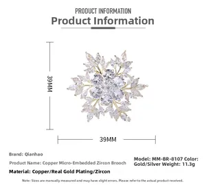 Detailed macro view showing the 39x39mm snowflake brooch with zircons and gold plating