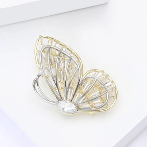 Elegant hollow double-layered butterfly brooch with sparkling cubic zirconia on a white stand