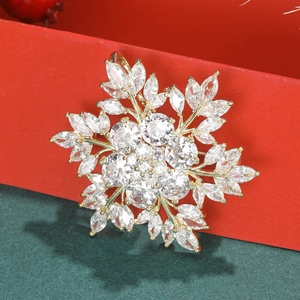 Elegant snowflake brooch with sparkling cubic zirconia on a festive red gift box background