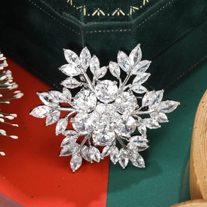 Close-up of snowflake brooch with zircon crystals on green velvet jewelry box