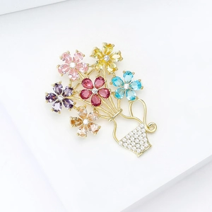 Detailed close-up of a vibrant multi-color zircon flower basket brooch with gold plating