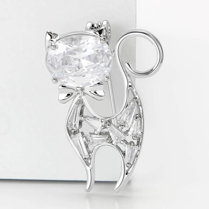Macro detail of the silver cat brooch showing pavé-set zircons and secure safety pin back