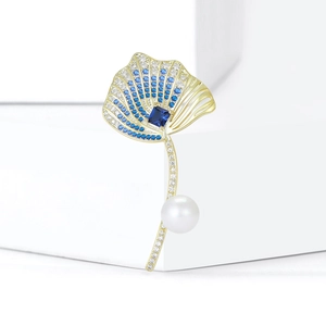 Elegant gold ginkgo leaf brooch with blue sapphire, white pearl and zircon accents