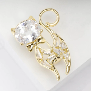 Macro shot of gold cat brooch with micro-pave cubic zirconia and a large oval main stone