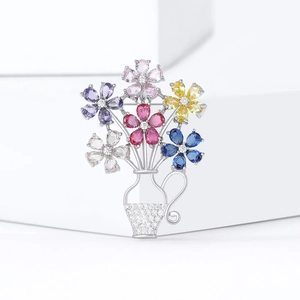 Elegant floral basket brooch with colorful zircon petals on minimalist white background