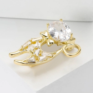 Macro shot of gold cat brooch featuring inlaid oval zircon and geometric crystals