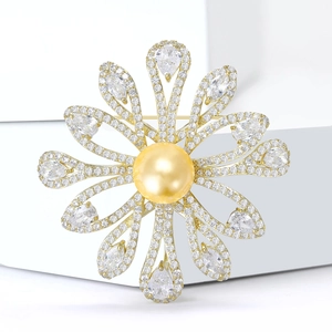 Detail of sunflower brooch featuring center pearl and zircon-encrusted petals in gold