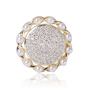 Detail view of sunflower brooch with white pearls and sparkling cubic zirconia stones