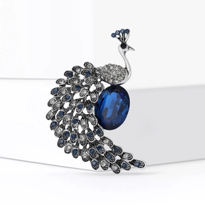 Fashionable silver peacock brooch pin with deep blue crystals and rhinestones