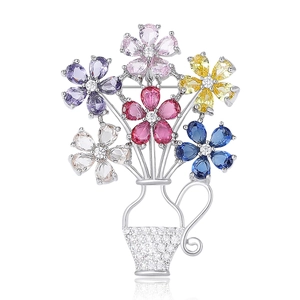 Elegant silver flower basket brooch featuring colorful cubic zirconia and a polished base