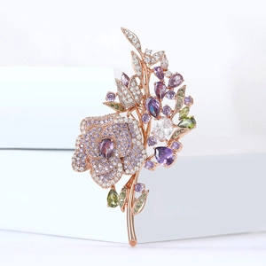 Detailed shot of rose gold flower brooch featuring white zircons and colorful gemstones