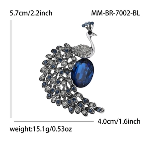 Elegant silver peacock brooch with navy blue crystals and sparkling white rhinestones