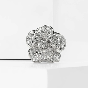 Close-up of a silver rose brooch featuring full pavé set white zircon flower petals