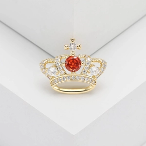Macro shot of crown ring featuring golden base with micro-set zircons and orange center stone