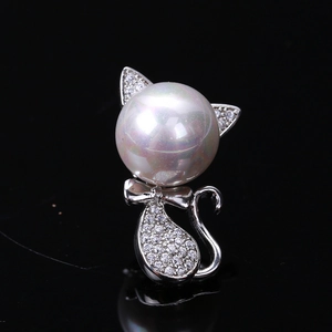 Detailed view of cat brooch with purple pearl head and sparkling zircon micro-inlays