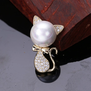 Detail showing cat brooch with glossy pearl head and sparkling cubic zirconia setting