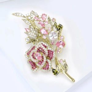 Detailed macro view of rose brooch with micro-pave white zircons and pink gemstones