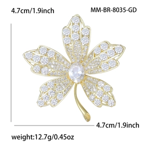 Elegant gold maple leaf brooch with sparkling cubic zirconia stones and clear leaf veins