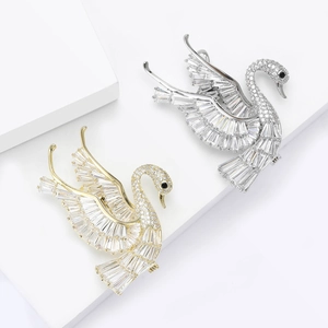 Elegant swan brooch set in gold and silver finish with sparkling cubic zirconia crystals