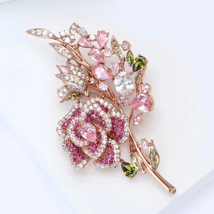 Detailed close-up of rose flower brooch with micro-pave zircons and colorful gemstones