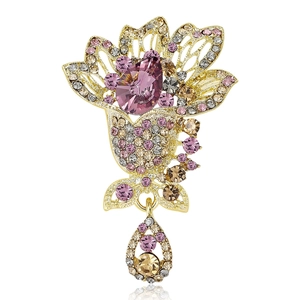 Elegant gold-plated floral brooch with pink crystals and teardrop pendant on white background