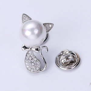 Detailed close-up of cute cat brooch with large pearl head and micro-set zircon crystals