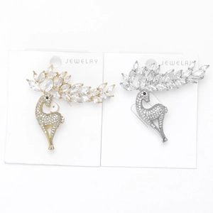 Detail of elegant gold and silver deer brooches with pavé-set marquise cubic zirconia