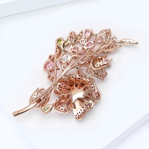 Detailed back view showing the pin fastener and rose gold plating on flower brooch
