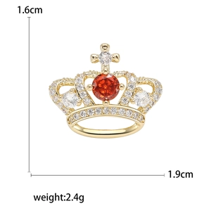 Luxury crown brooch with sparkling zircons and red gemstone in gold plating