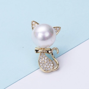 Macro detail of cat brooch featuring large high-luster white pearl and cubic zirconia
