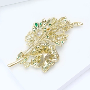 Detailed back view of golden rose brooch with micro-pave zircons and openwork metal craft