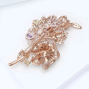 Macro shot of rose gold flower brooch showing detailed back structure and pin clasp