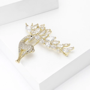 Macro view of golden peacock brooch featuring sparkling marquise-cut zircon crystals