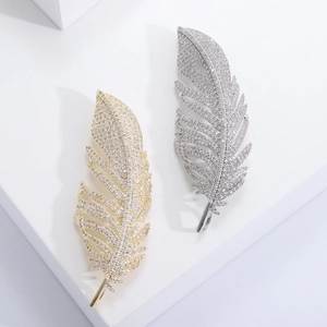 Elegant zircon feather brooch set in gold and silver finish with detailed stone inlay
