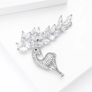 Macro detail of silver deer brooch with marquise cut zircon crystals and branch antlers