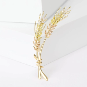 Detail of elegant gold wheat brooch with gradient yellow marquise-cut zircon stones
