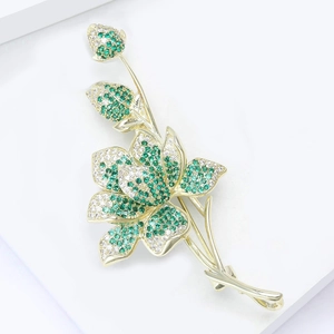 Exquisite flower brooch with green and white zircons set in a premium gold metal finish