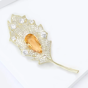 Elegant leaf-shaped brooch with champagne drop gemstone and white cubic zirconia crystals