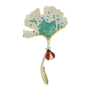 Ginkgo leaf brooch with green gradient cubic zirconia and a small ladybug
