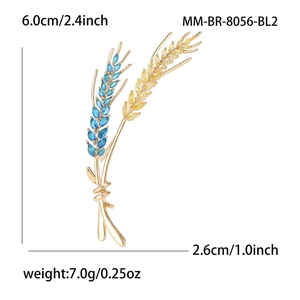 Elegant wheat stalk brooch with gold finish, featuring yellow and blue marquise crystals